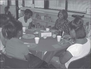 Stallworth and middle school students discussing Ties That Bind, Ties That Break.