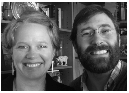 Photograph of a woman and a man looking into the camera and smiling. They appear to be friends.