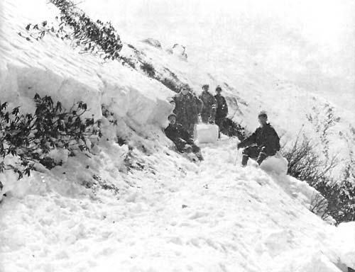 J. F. Rock and Nashi cutting trail near summit of Dakhe la