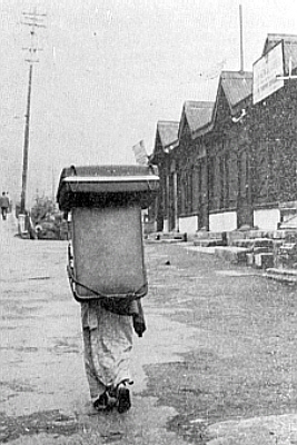 Darjeeling woman carrying luggage