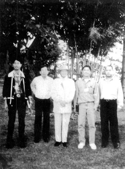 The staff at Doi Tung and the
author's wife, Jean, with a 100-year-old R. argipeplum relocated from China.